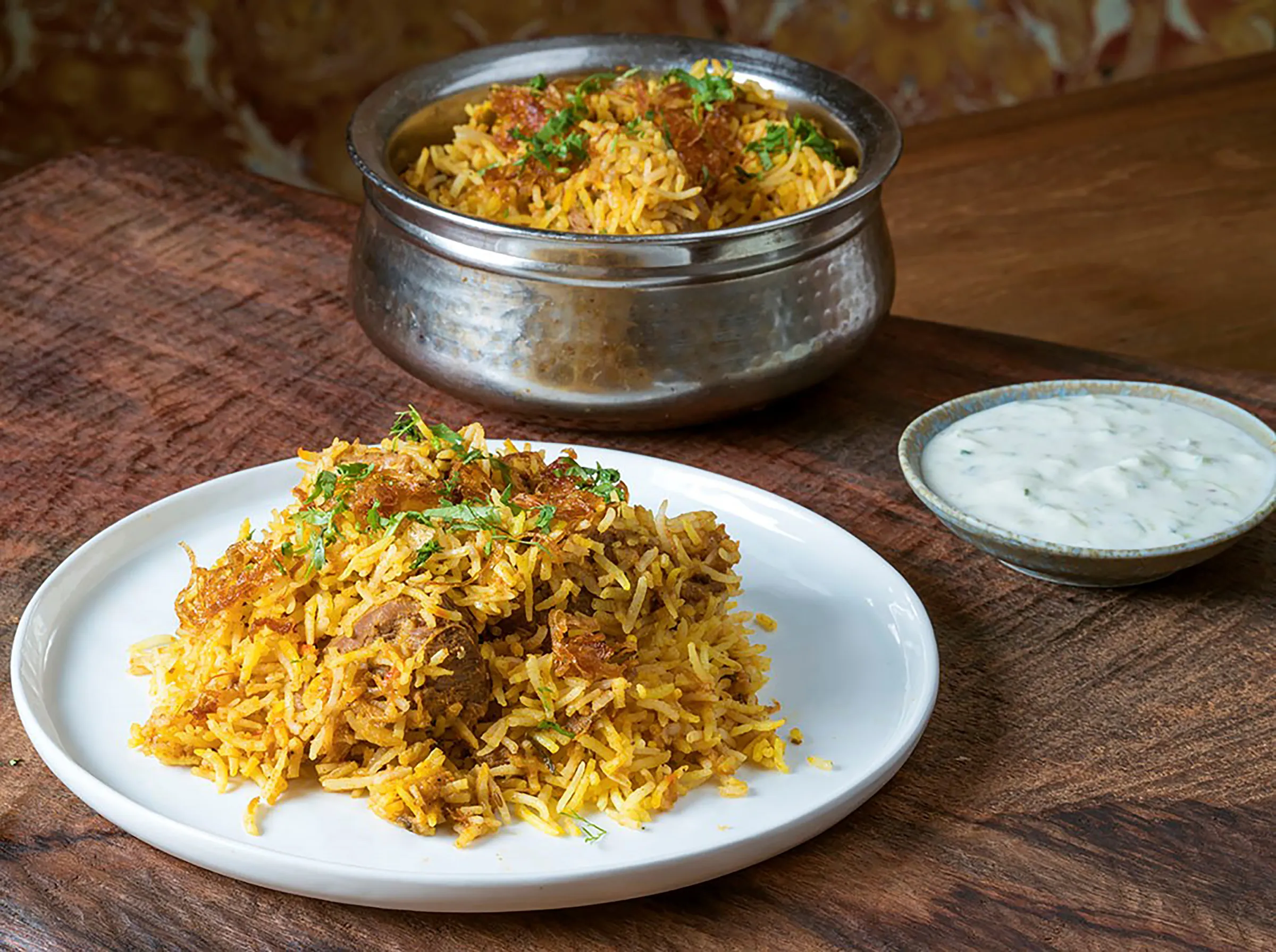 Rice on a white plate on a wooden table.
