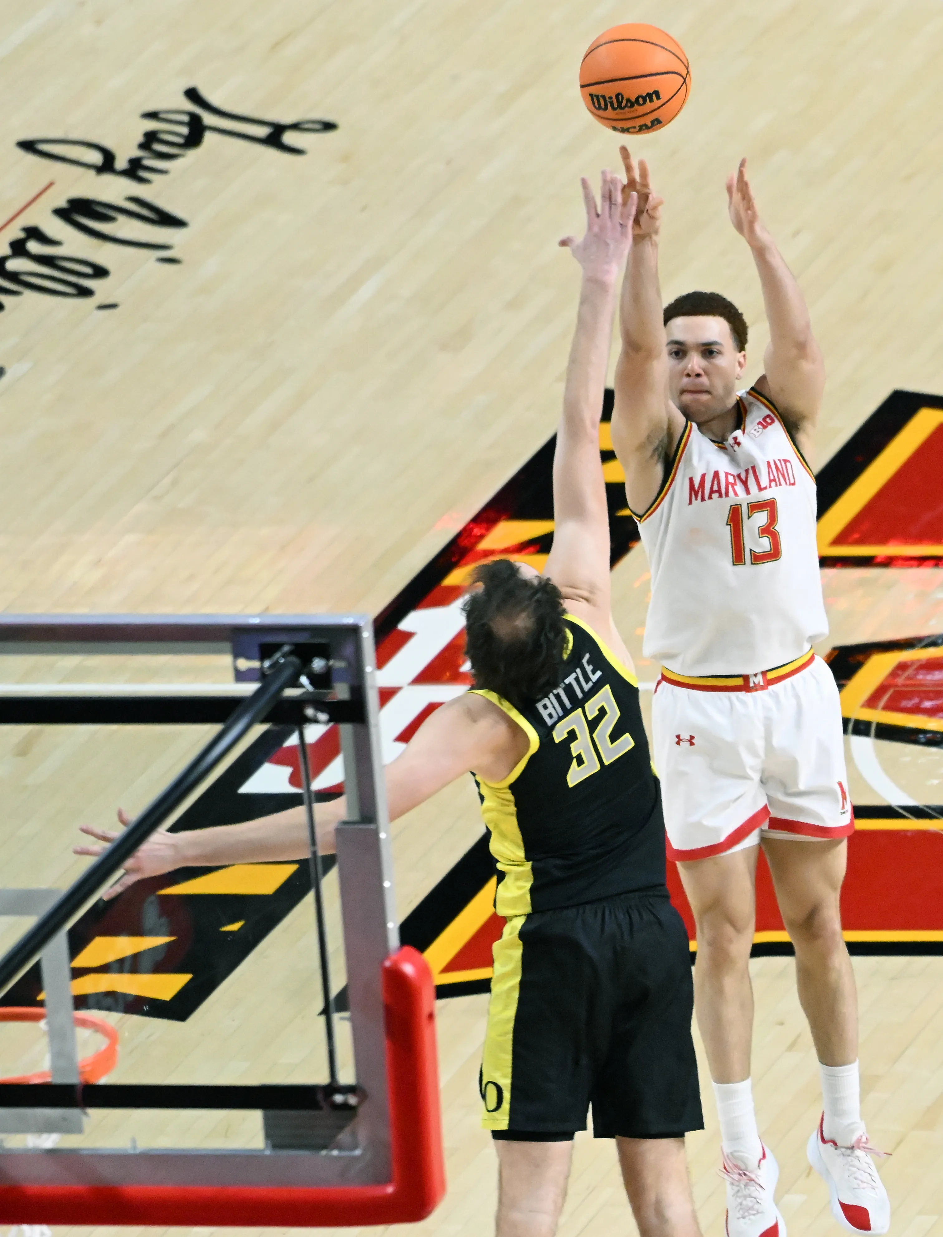 Maryland’s Elijah Saunders takes a shot as Oregon’s Nate Bittle...