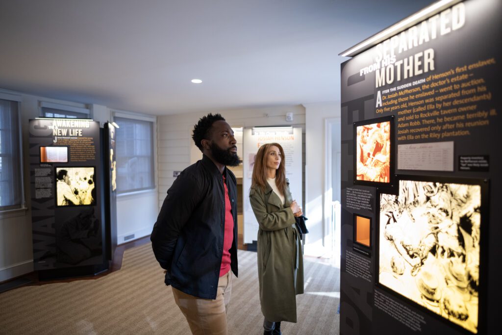 couple viewing an exhibit at the Josiah Henson Museum and Park