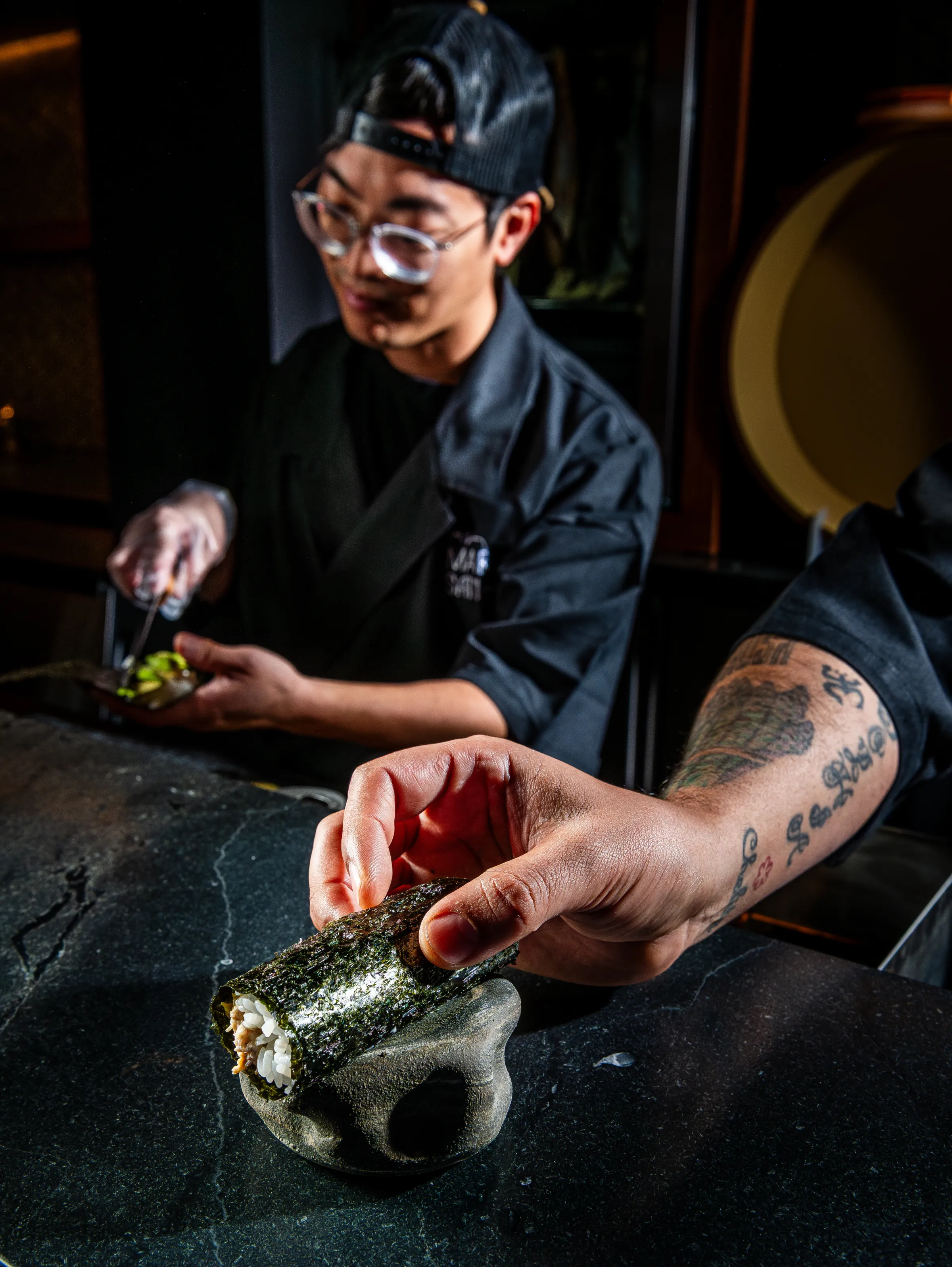 Chef Simon Lam and Delgado prep handrolls.
