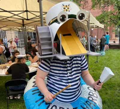 A person dressed in a Captain Trash Wheel costume