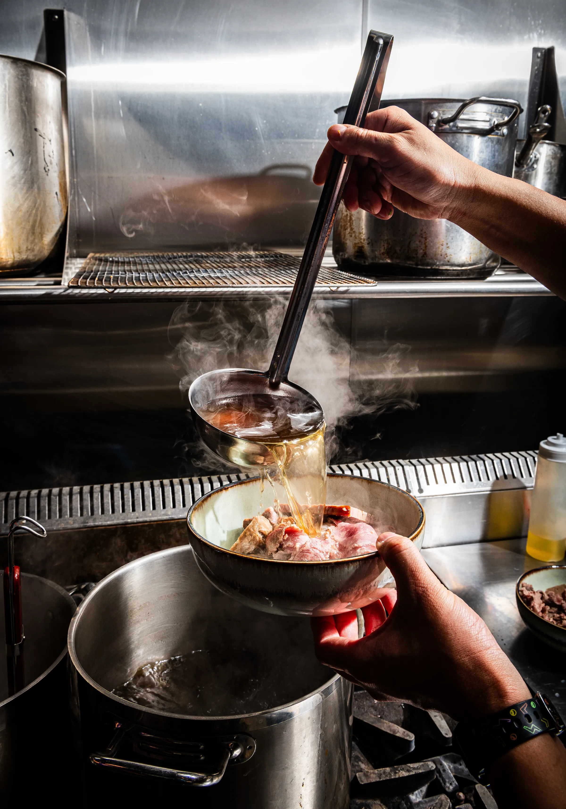 The brisket is slow-cooked for 12 to 15 hours before being added to pho.