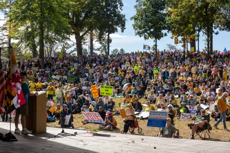 view of crowd from stage with trees and blue sky