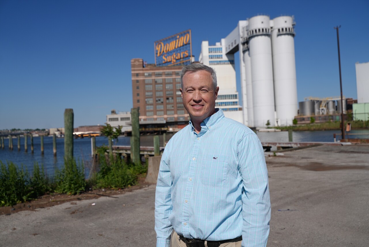 O'Malley in front of the sign