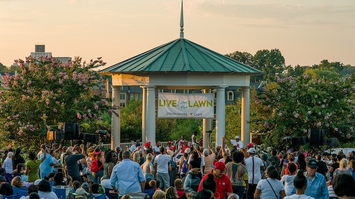a gazebo with people around listening to music