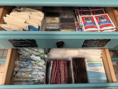 green dresser drawers open and filled with toiletries and reproductive health supplies