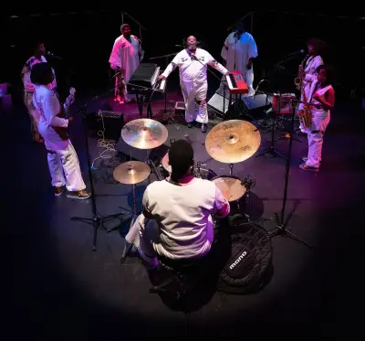 photo from above of six-person band, spotlit from above