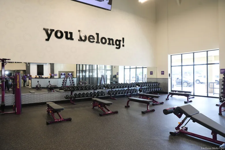weight room with "you belong!" in letters on wall